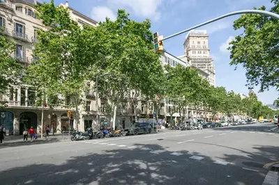 a street with cars parked on the side of the road at Alcam Paseo de Gracia in Barcelona
