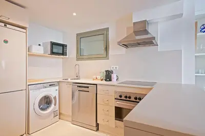 a kitchen with a washing machine and a washer at Alcam Paseo de Gracia in Barcelona