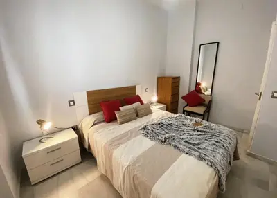 a bedroom with a large bed and a mirror at Cristina in Arenys de Mar