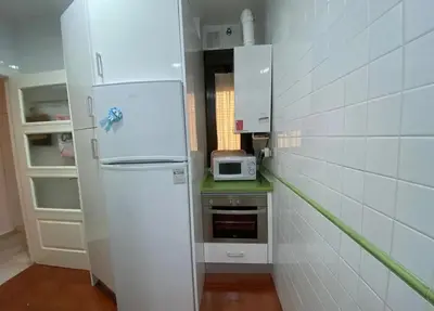 a white refrigerator in a kitchen with a microwave at Cristina in Arenys de Mar