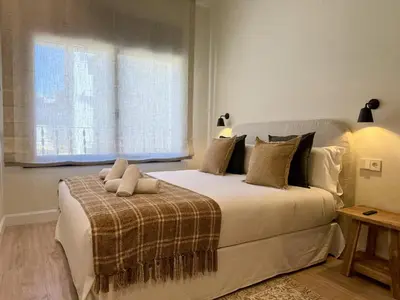 a bedroom with a large white bed with a window at 'The Residences At Bartomeu 26 ' Suite Benazet in Sitges