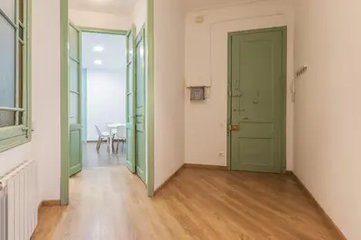 a hallway with a green door and a dining room at Modernist Apartment 2 in Barcelona