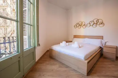 a bedroom with a bed with two towels on it at Modernist Apartment 2 in Barcelona