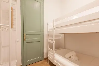 a bedroom with two bunk beds and a door at Modernist Apartment 2 in Barcelona