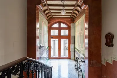 a hallway with a red door in a building at Modernist Apartment 2 in Barcelona