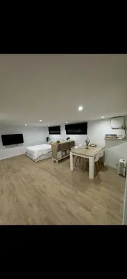 a bedroom with a bed and a tv in it at Apartamento colibrí in Sitges
