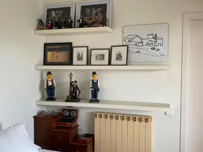 a bedroom with shelves with figurines on the wall at Apart Villa Cristina 5 min walk to the beach RoofTop Duplex 180 M2 Very Cared in Sitges