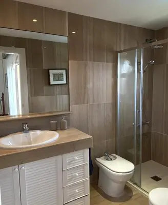 a bathroom with a toilet and a sink and a shower at Apart Villa Cristina 5 min walk to the beach RoofTop Duplex 180 M2 Very Cared in Sitges