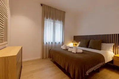 a living room with a couch and a table at Lodging Apartments Besos River B1 in Santa Coloma