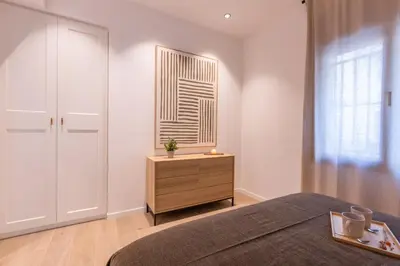 a small room with a bed and a window at Lodging Apartments Besos River B1 in Santa Coloma