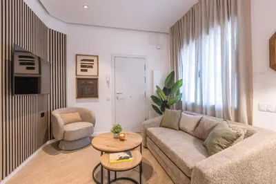 a living room with a couch and a table at Lodging Apartments Besos River B1 in Santa Coloma
