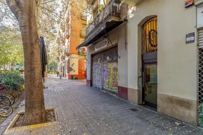 a cobblestone street next to a building with a tree at 2537 - AB Sant Antoni Studio in Barcelona