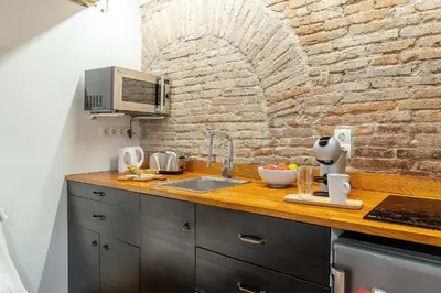 a kitchen with a sink and a brick wall at 2537 - AB Sant Antoni Studio in Barcelona