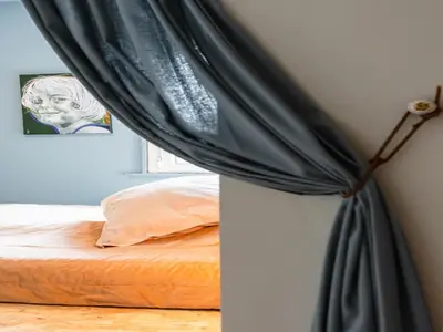 a bedroom with a bed with a black curtain at Designer villa with sauna and swimming pool in Canyelles