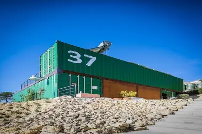 a green building with the number on it at Designer villa with sauna and swimming pool in Canyelles