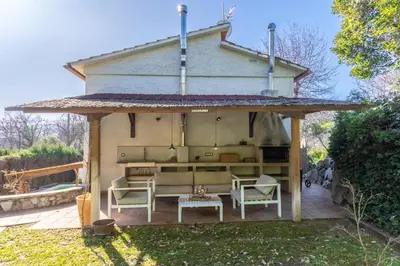 a gazebo with chairs and a table at Casa con encanto a los pies del Montseny in La Batlloria