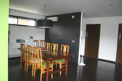 a dining room with a wooden table and chairs at Casa ceca de la Playa y Barcelona, con piscina climatizada y jacuzzi in Vallromanas