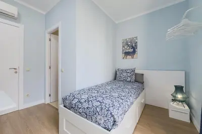 a bedroom with a bed in a white room at Habitación 5 con baño junto al Palau Güell in Barcelona