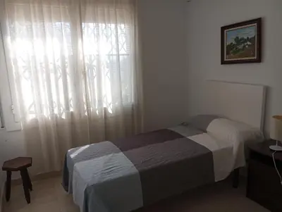 a bedroom with a bed in front of a window at Un lugar tranquilo y relajado in La Salud
