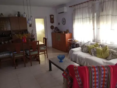 a living room with a couch and a dining room at Un lugar tranquilo y relajado in La Salud