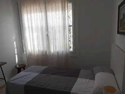 a bedroom with a bed in front of a window at Un lugar tranquilo y relajado in La Salud