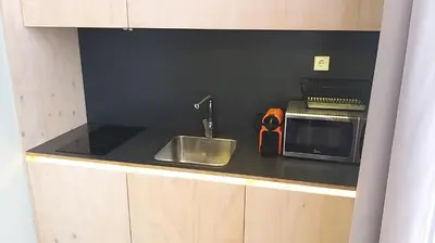 a kitchen with a sink and a microwave at Casa Abamita in Barcelona