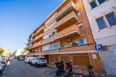 a building with bikes parked next to a parking lot at HomeHolidaysRentals Magic - Costa Barcelona in Pineda de Mar