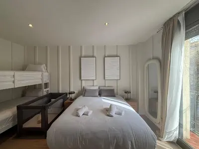 a bedroom with a large bed with towels on it at Creu Coberta in Barcelona