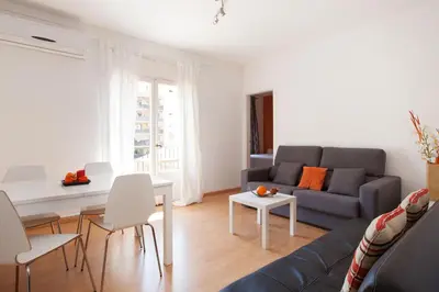 a living room with a couch and a table at YOUR HOME - Sagrada Familia Apartment in Barcelona