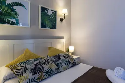 a bedroom with a bed and two lamps on a wall at 4 Bedroom High-Rise Apartment Amazing views! in Barcelona