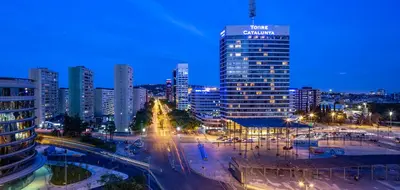 a city skyline at night with a tall building at 4 Bedroom High-Rise Apartment Amazing views! in Barcelona
