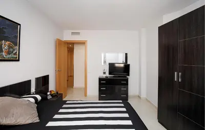 a bedroom with a bed and a flat screen tv at Beautiful Apartment In Pineda De Mar in Pineda de Mar