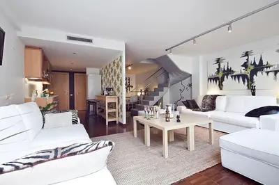 a living room with two white couches and a table at My Space Barcelona Private Pool Garden in Barcelona