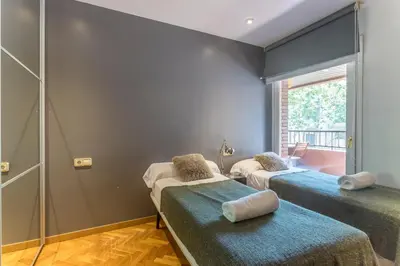 a room with three beds and a shower at My Space Barcelona Bonanova Center in Barcelona