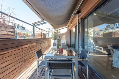 a patio with a table and chairs on a building at My Space Barcelona Penthouse Terrace in Barcelona