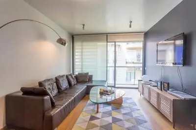 a living room with a couch and a tv at My Space Barcelona Penthouse Terrace in Barcelona