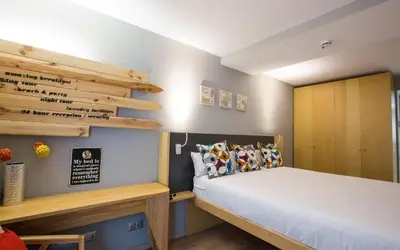 a bedroom with a bed and a wooden cabinet at Yeah Barcelona Hostel in Barcelona