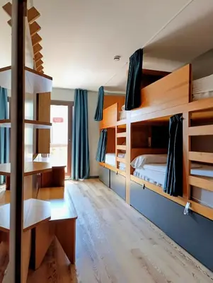 a room with bunk beds and a desk and a bed at Yeah Barcelona Hostel in Barcelona