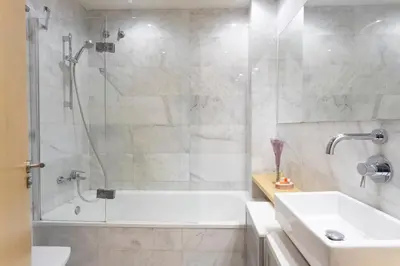 a bathroom with a shower and a tub and a sink at My Space Barcelona Gracia Pool Terrace in Barcelona