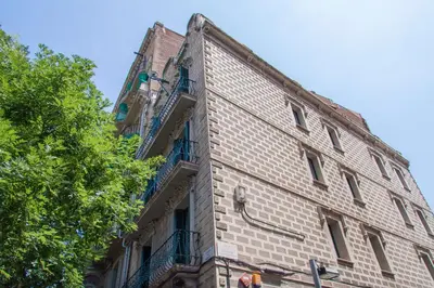 a tall brick building with balconies on the side of it at Sweett - Sants in Barcelona