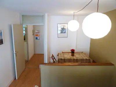a room with a table and two lights at Joanic Apartment Escorial in Barcelona