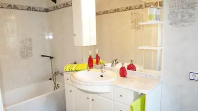 a white bathroom with a sink and a shower at Villa Carolina in Mataró