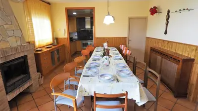 a dining room with a long table and chairs at Villa Carolina in Mataró