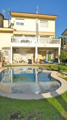 a large swimming pool in front of a house at Villa Carolina in Mataró