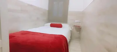 a small room with a bed with a red blanket at Maria House. in Viladecáns