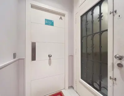 a white door in a hallway next to a shower at Stay U-nique Apartments Fontanella in Barcelona