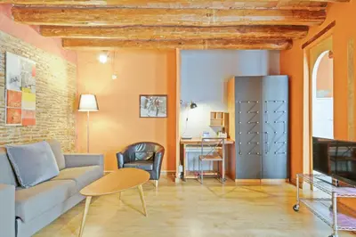 a living room with a couch and a refrigerator at Alcam Flassaders in Barcelona
