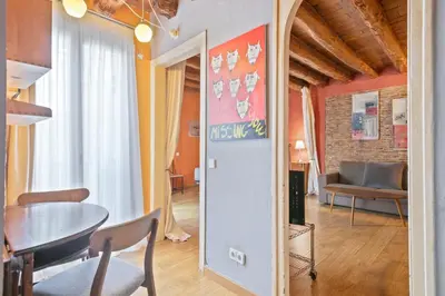 a living room with a table and a couch at Alcam Flassaders in Barcelona