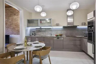 a kitchen with a table and chairs in a kitchen at Alcam Trafalgar in Barcelona