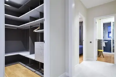a walk in closet with black shelves in a room at Alcam Trafalgar in Barcelona